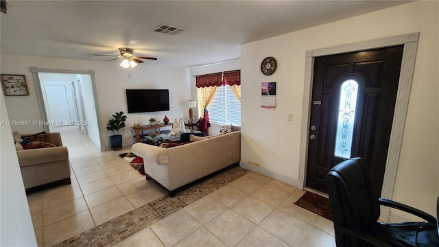living room with ceiling fan, light tile patterned flooring, baseboards, and visible vents