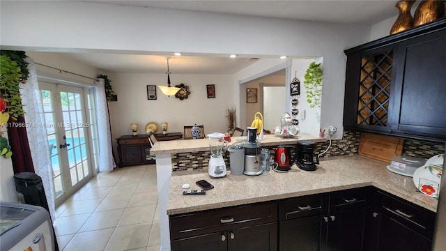 kitchen with a peninsula, hanging light fixtures, french doors, decorative backsplash, and light tile patterned flooring