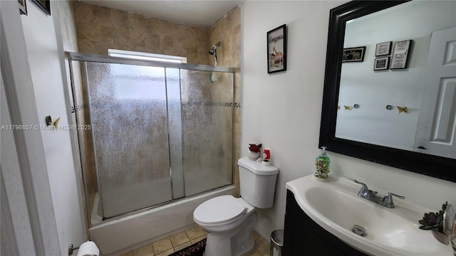 full bathroom featuring toilet, tile patterned flooring, vanity, and shower / bath combination with glass door
