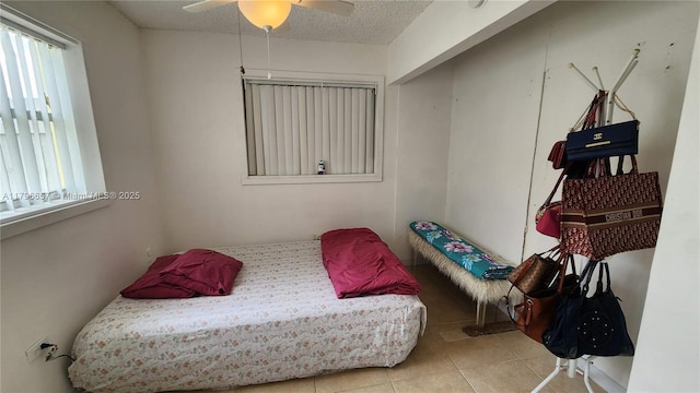 bedroom with a ceiling fan and tile patterned flooring