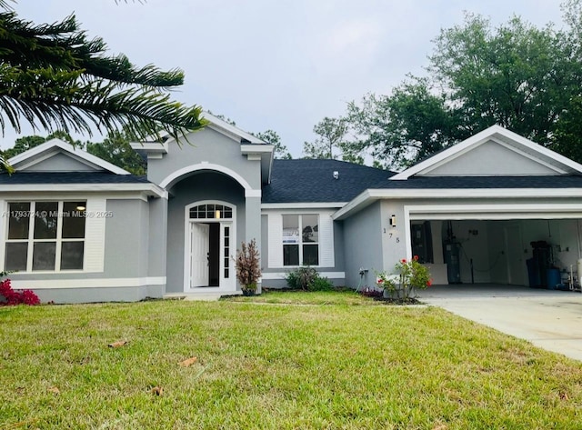 view of front of home with a front lawn, driveway, stucco siding, and a garage
