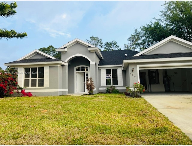 ranch-style house featuring concrete driveway, stucco siding, an attached garage, and a front yard
