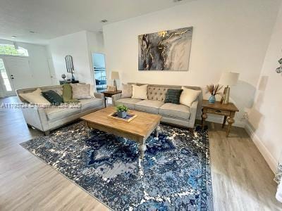 living area with wood finished floors and baseboards