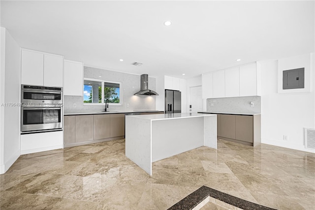 5510 NE 18th Ave, Fort Lauderdale, FL 33334 - kitchen with modern cabinets, decorative backsplash, wall chimney exhaust hood, electric panel, and appliances with stainless steel finishes