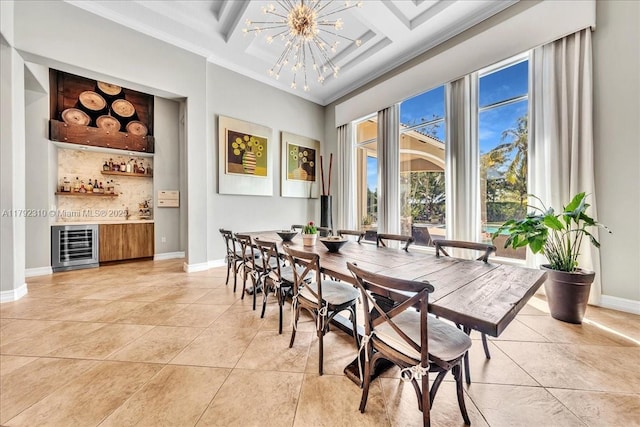 dining space featuring beverage cooler, crown molding, baseboards, a dry bar, and light tile patterned flooring