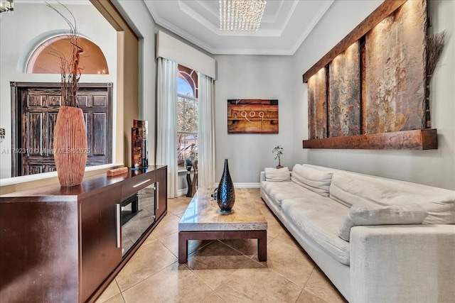 sitting room featuring light tile patterned floors, a raised ceiling, a chandelier, and crown molding