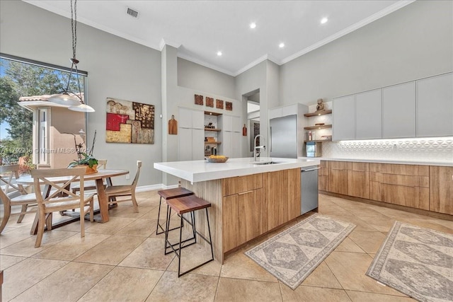 kitchen with light tile patterned floors, a sink, open shelves, modern cabinets, and a towering ceiling