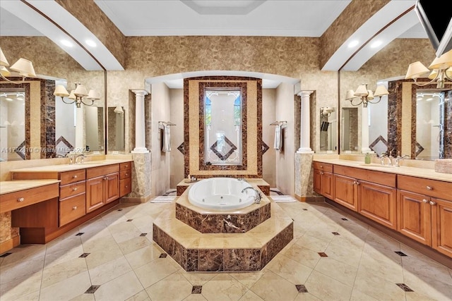 full bathroom featuring a bath, a sink, tile patterned flooring, two vanities, and ornate columns