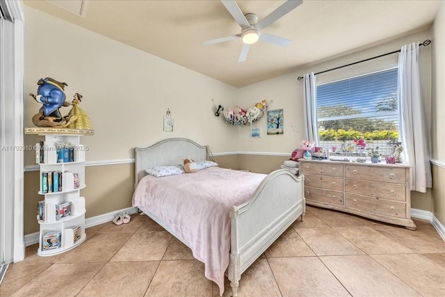 bedroom featuring light tile patterned floors, baseboards, and ceiling fan