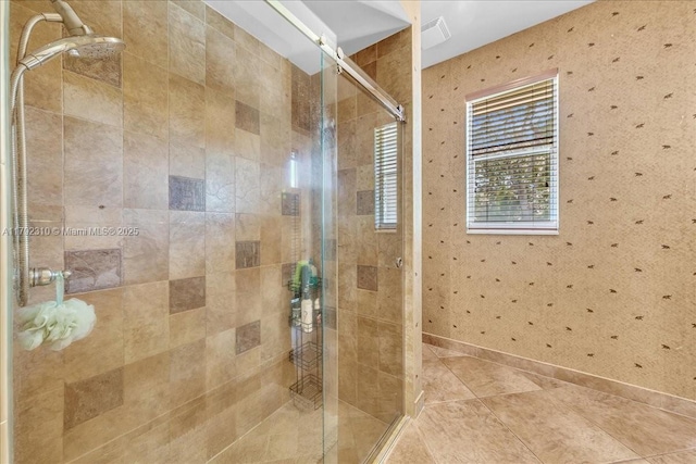 bathroom with tile patterned floors, visible vents, baseboards, and a shower stall
