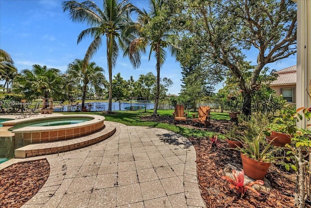 view of property's community featuring a water view, a patio area, and a hot tub