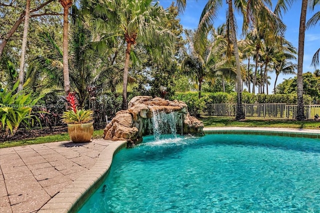 view of swimming pool featuring fence and a fenced in pool
