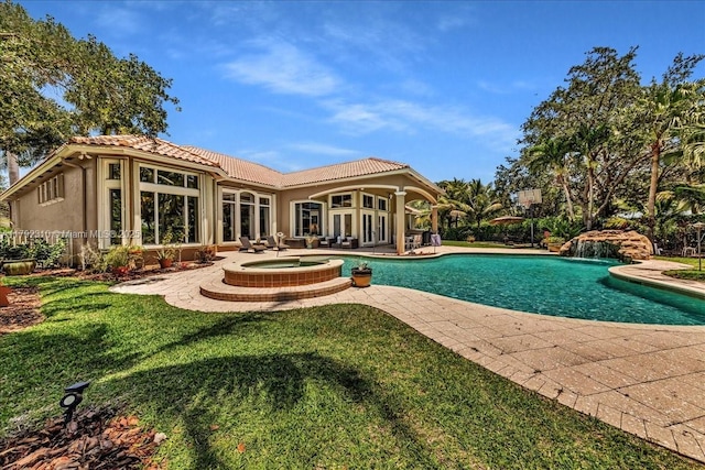rear view of house with a lawn, a pool with connected hot tub, a patio area, stucco siding, and a tile roof