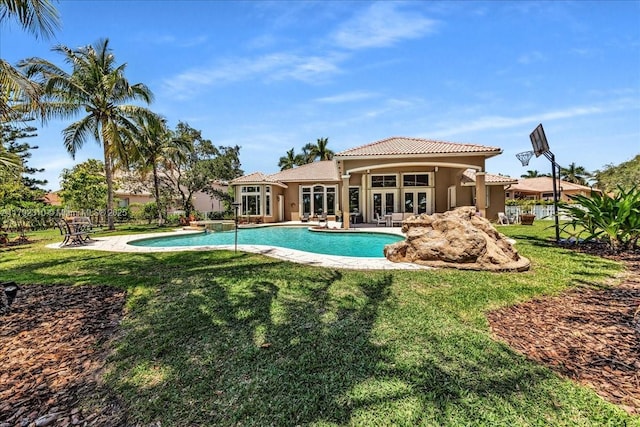 pool with a yard, a patio, and french doors