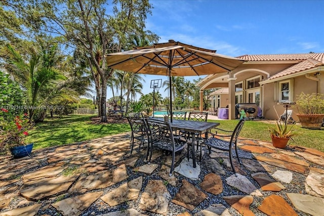 view of patio with outdoor dining area and fence
