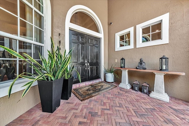 property entrance featuring stucco siding