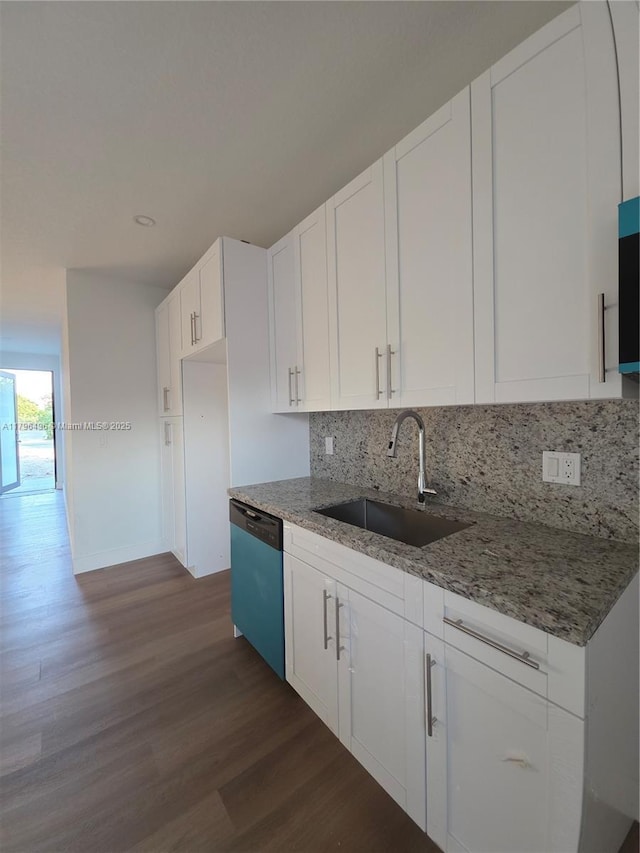 kitchen featuring a sink, dishwashing machine, dark wood-type flooring, backsplash, and light stone countertops