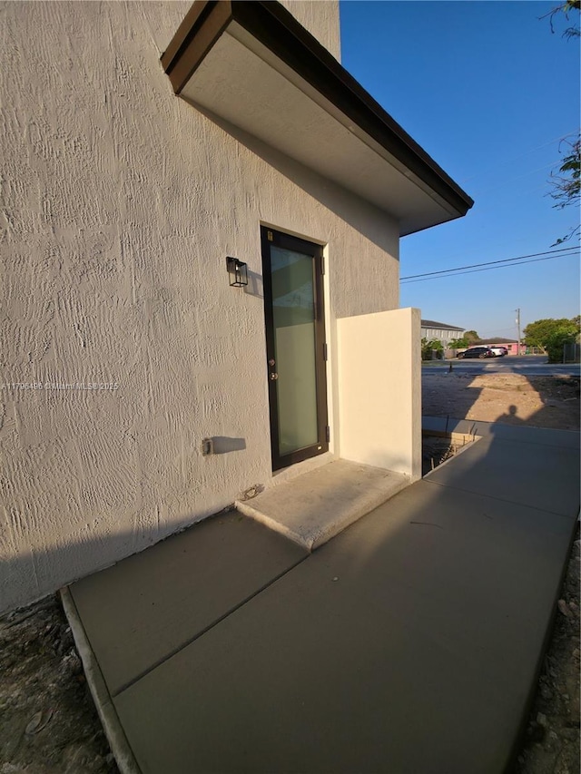 view of exterior entry featuring stucco siding