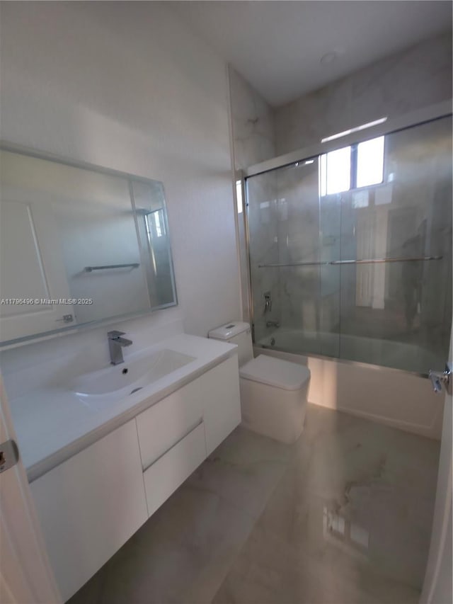 full bath featuring vanity, toilet, bath / shower combo with glass door, and marble finish floor
