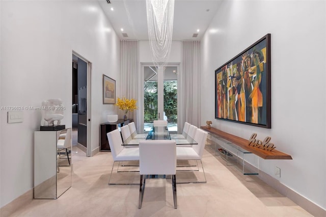dining area featuring a high ceiling and recessed lighting