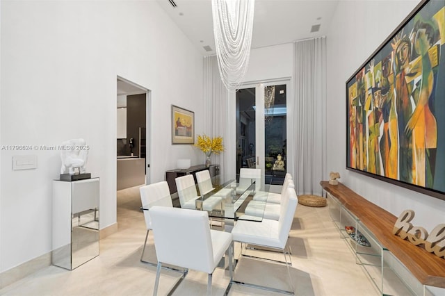 dining area featuring a high ceiling