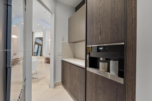 bar featuring freestanding refrigerator, oven, and baseboards