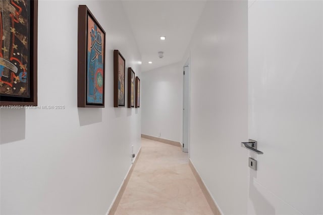 hall featuring baseboards and recessed lighting