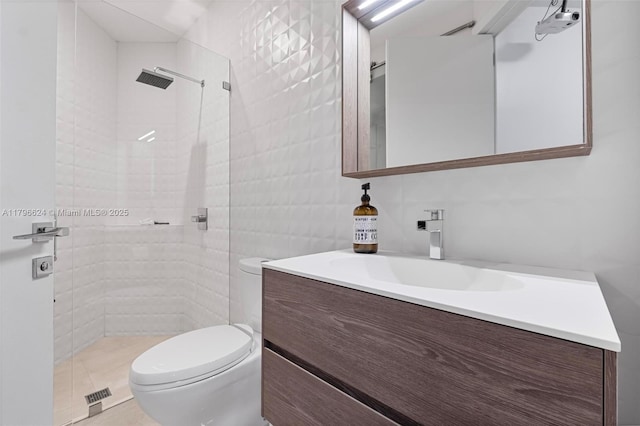 full bath featuring tile walls, toilet, vanity, and tiled shower