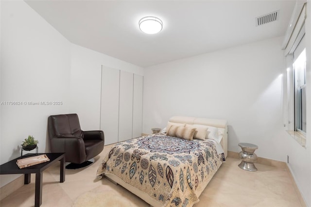 bedroom with a closet and visible vents
