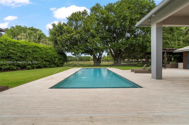 pool with a yard, fence, a patio area, and a deck