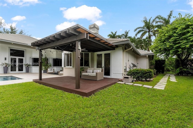back of property featuring a wooden deck, stucco siding, french doors, and a chimney