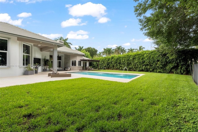 view of pool with a lawn, a patio area, a fenced in pool, and a fenced backyard