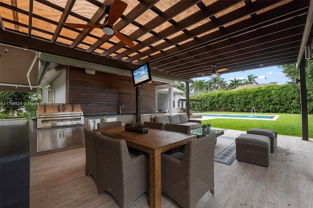 view of patio / terrace with a grill, exterior kitchen, outdoor dining area, ceiling fan, and a fenced in pool