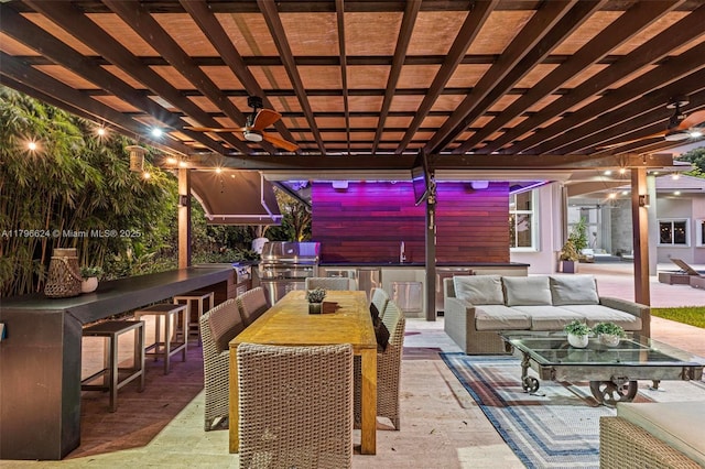 view of patio with an outdoor kitchen, area for grilling, outdoor lounge area, a pergola, and outdoor wet bar