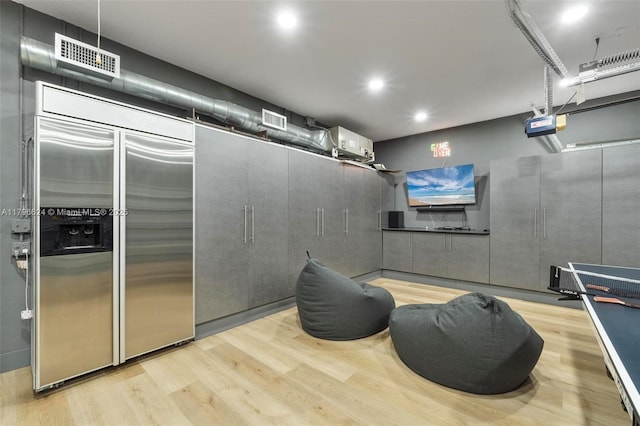 misc room with recessed lighting, visible vents, and wood finished floors