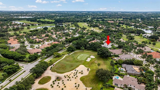 bird's eye view with view of golf course, a water view, and a residential view