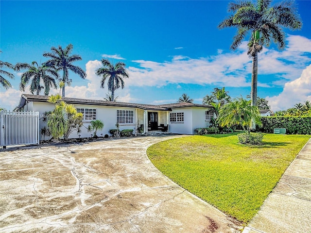 17931 NW 85th Ave, Hialeah, FL 33015 - single story home featuring stucco siding, driveway, and a gate