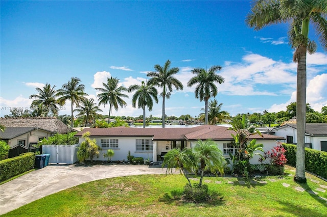 17931 NW 85th Ave, Hialeah, FL 33015 - single story home featuring a gate, stucco siding, concrete driveway, and a water view