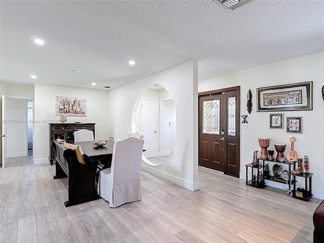 17931 NW 85th Ave, Hialeah, FL 33015 - dining room with a textured ceiling, light wood-style flooring, arched walkways, and recessed lighting