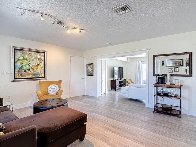17931 NW 85th Ave, Hialeah, FL 33015 - living room featuring light wood-type flooring and a textured ceiling