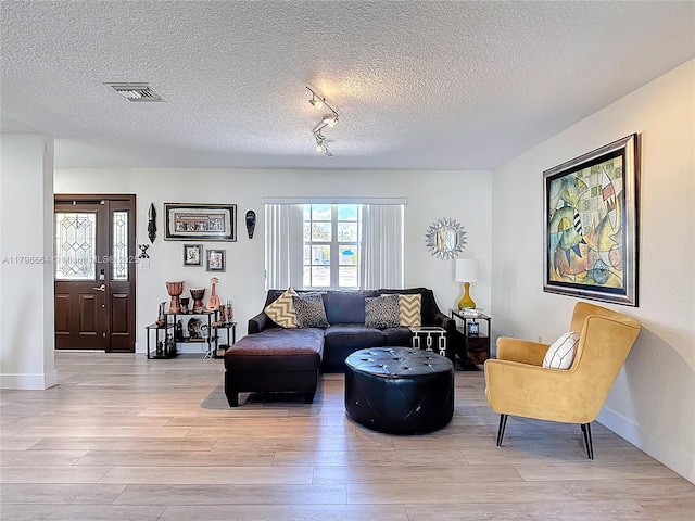 17931 NW 85th Ave, Hialeah, FL 33015 - living area featuring light wood-style flooring, a textured ceiling, and track lighting