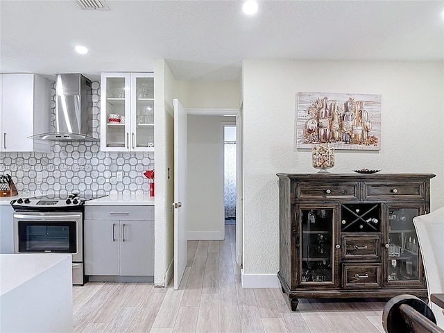 17931 NW 85th Ave, Hialeah, FL 33015 - kitchen featuring wall chimney exhaust hood, electric stove, light countertops, backsplash, and recessed lighting