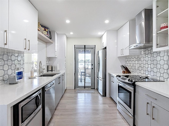 17931 NW 85th Ave, Hialeah, FL 33015 - kitchen with wall chimney range hood, stainless steel appliances, open shelves, modern cabinets, and light countertops