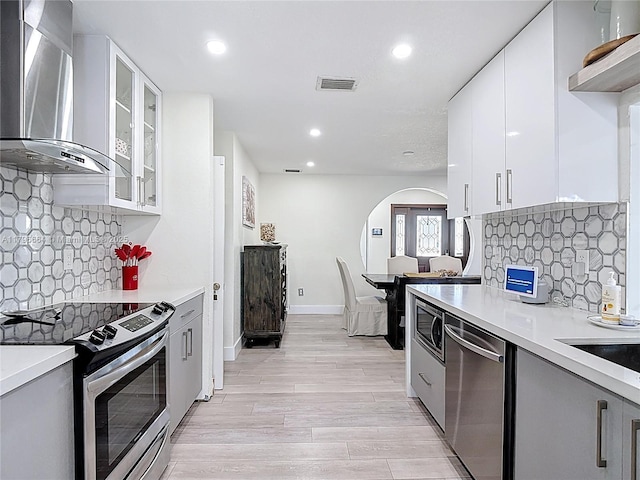 17931 NW 85th Ave, Hialeah, FL 33015 - kitchen featuring wall chimney range hood, appliances with stainless steel finishes, recessed lighting, light countertops, and modern cabinets