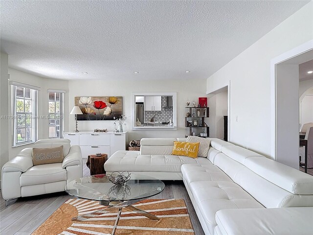 17931 NW 85th Ave, Hialeah, FL 33015 - living area with light wood-type flooring, a textured ceiling, recessed lighting, and arched walkways