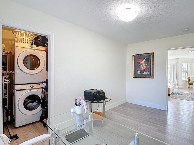 17931 NW 85th Ave, Hialeah, FL 33015 - washroom featuring stacked washer / drying machine, a textured ceiling, and wood finished floors