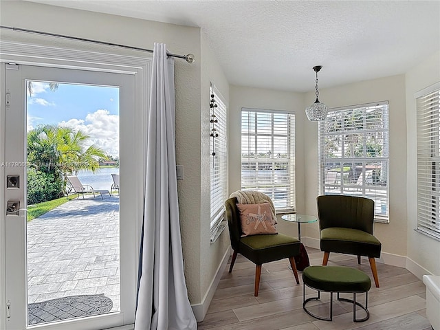 17931 NW 85th Ave, Hialeah, FL 33015 - sitting room with wood finished floors, a textured wall, and a textured ceiling