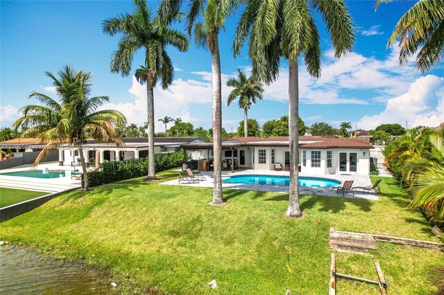 17931 NW 85th Ave, Hialeah, FL 33015 - outdoor pool with french doors, a patio area, and a lawn