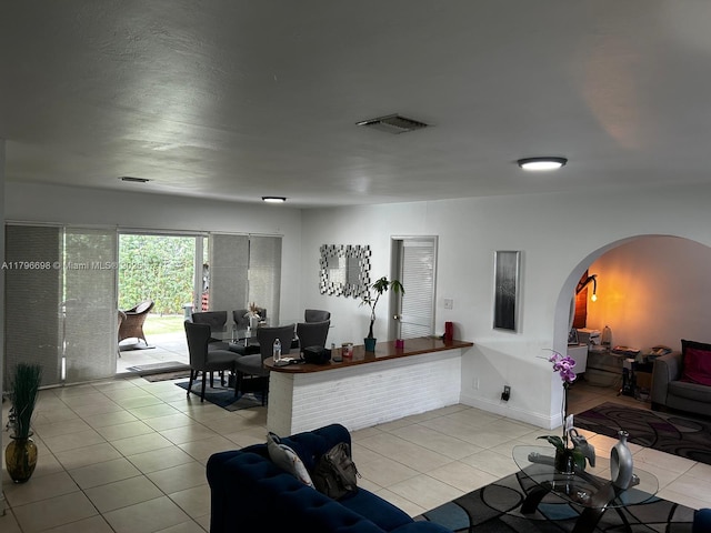 5718 Monroe St, Hollywood, FL 33023 - living room featuring arched walkways, light tile patterned floors, and visible vents