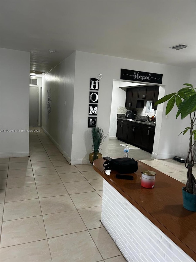 5718 Monroe St, Hollywood, FL 33023 - hall with a sink, baseboards, light tile patterned floors, and visible vents